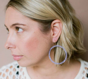 Side profile of a woman wearing Denz Triangle Hoop Earrings in Lilac 