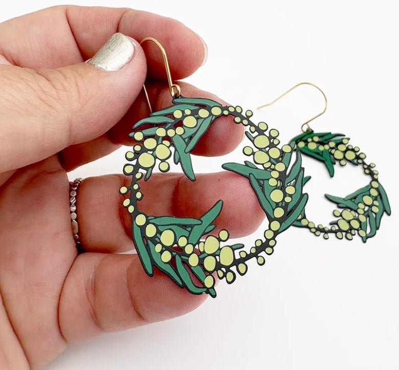 Denz Wattle Wreath Earrings in Black/Green/Yellow, held by hand