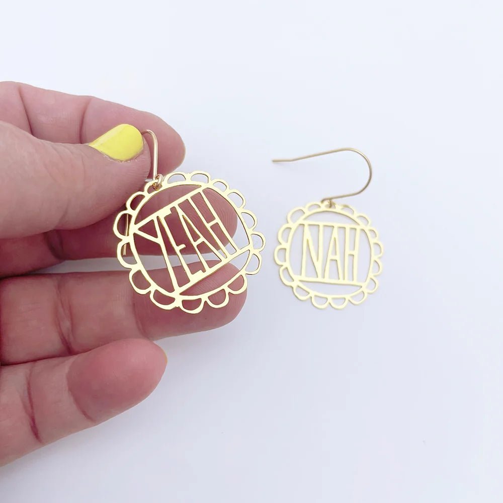 DENZ MIni Yeah Nah Earrings in Gold, held by hand