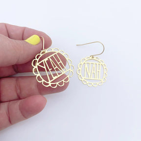 DENZ MIni Yeah Nah Earrings in Gold, held by hand