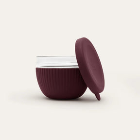 Seed & Sprout 1000ml glass lunch bowl in Mulberry featuring a ribbed protective silicone base and a matching leakproof lid displayed.