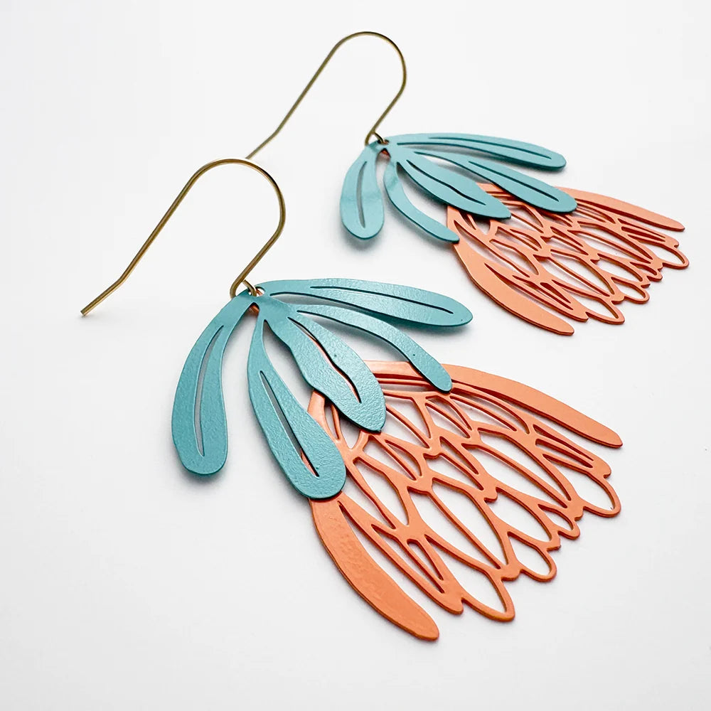 Pair of DENZ Protea Flower dangle earrings leaf-like designs on a white background