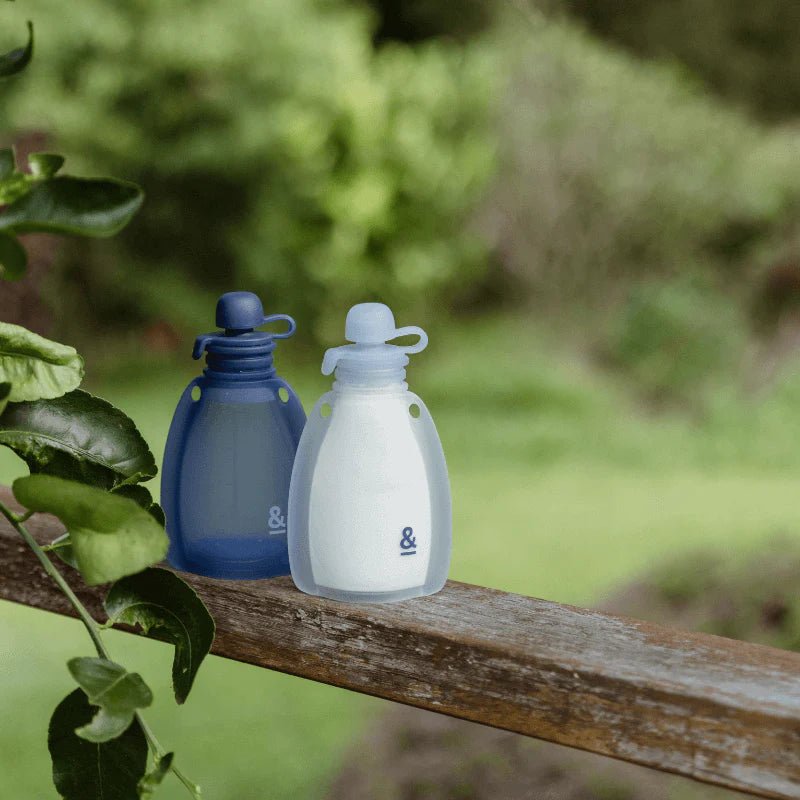 Seed & Sprout Reusable Yoghurt Pouches Indigo, 2-pack, outdoors on a tree branch