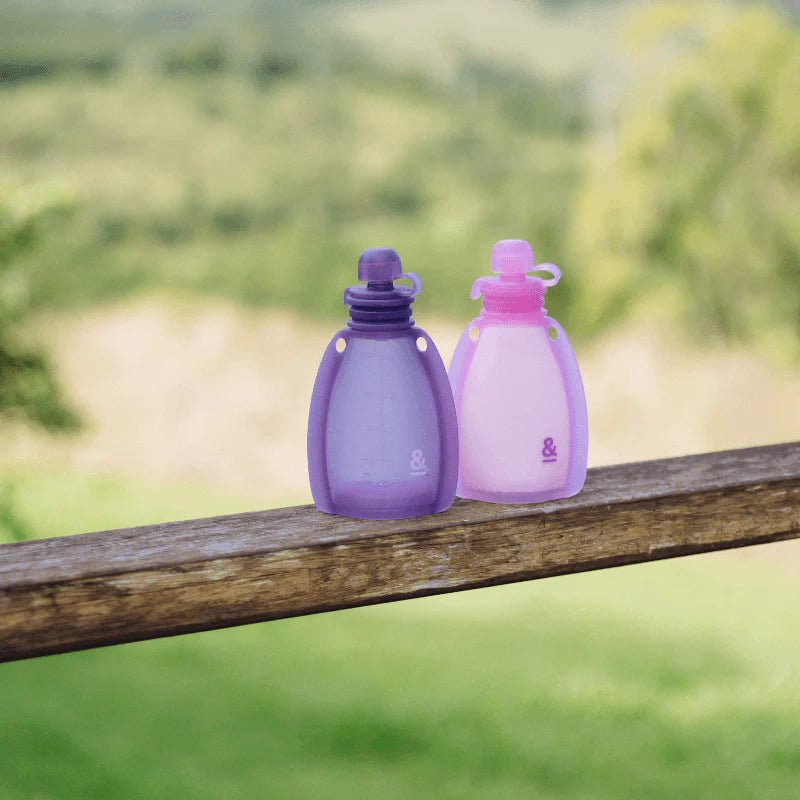 Seed & Sprout Reusable Yoghurt Pouches Plum, 2-pack, outdoors on a tree branch