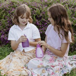 Kids holding Seed & Sprout Reusable Yoghurt Pouches Plum, eco-friendly snack bag