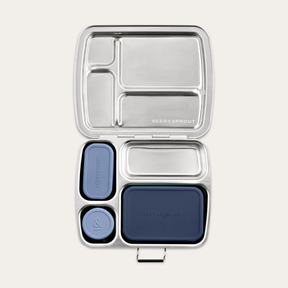 Seed & Sprout CrunchBox stainless steel bento lunch box featuring partitioned compartments and three leakproof silicone pots in indigo tones.