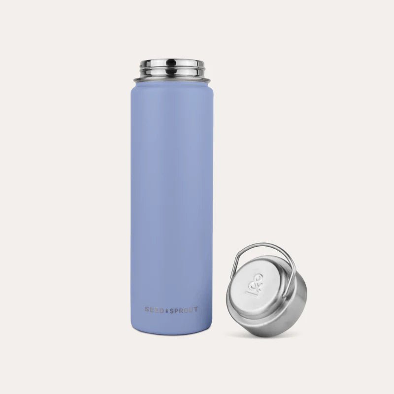 Seed and Sprout Durable 650ml Insulated Stainless Steel Drink Bottle in River standing upright next to its unscrewed silver cap with a carry loop.