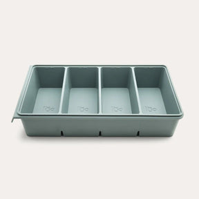 An open Seed & Sprout 4 Portion Silicone Freezer Tray in eucalyptus featuring four empty internal compartments.