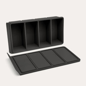 An open Seed & Sprout 4 Portion Silicone Freezer Tray displayed angled above its matching flat-lying lid.