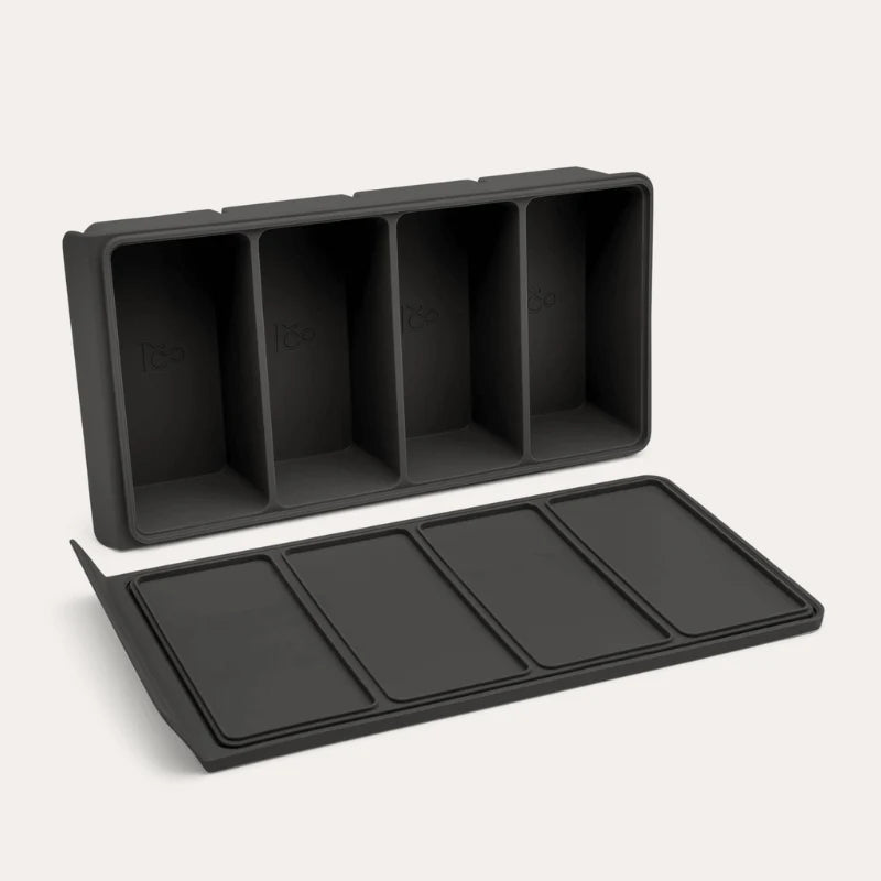 An open Seed & Sprout 4 Portion Silicone Freezer Tray displayed angled above its matching flat-lying lid.