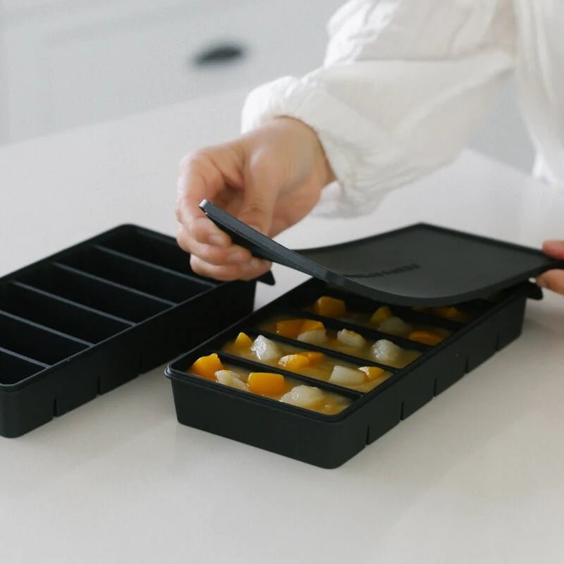 Seed & Sprout Silicone 6 portion Freezer Tray filled with fruit prep and being sealed.