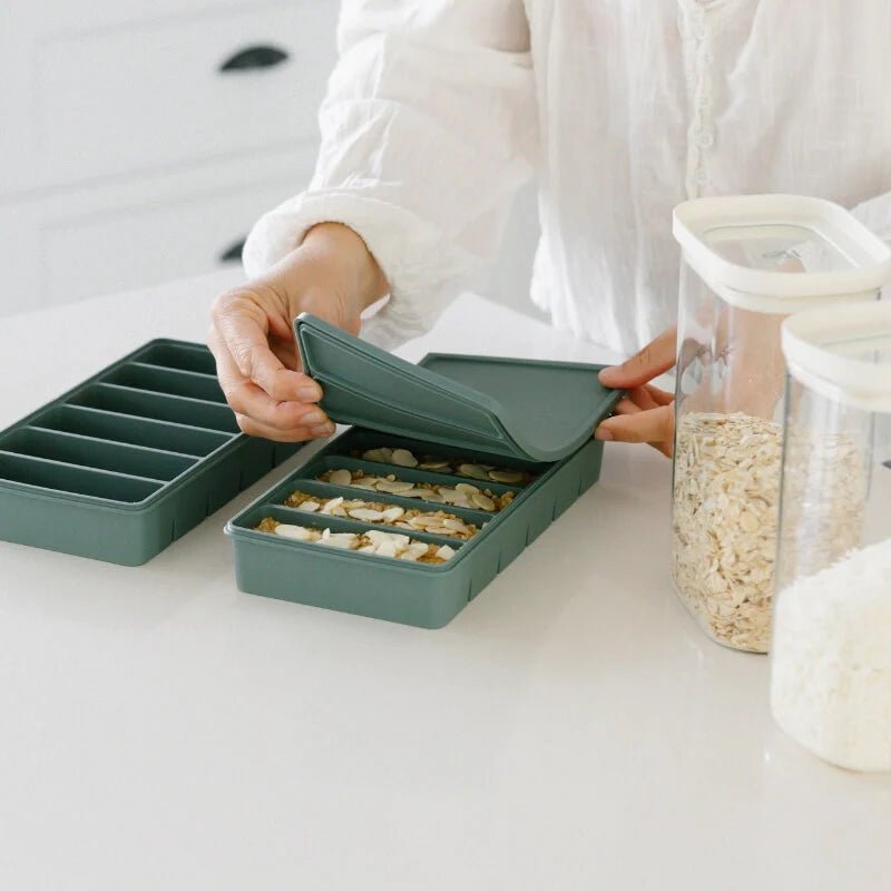 Seed & Sprout 6 Portion Silicone Freezer Tray in Eucalyptus being sealed in a kitchen setting.