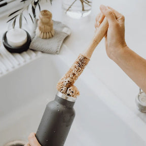Seed & Sprout Beechwood Bottle Cleaning Brush washing a stainless steel drink bottle.