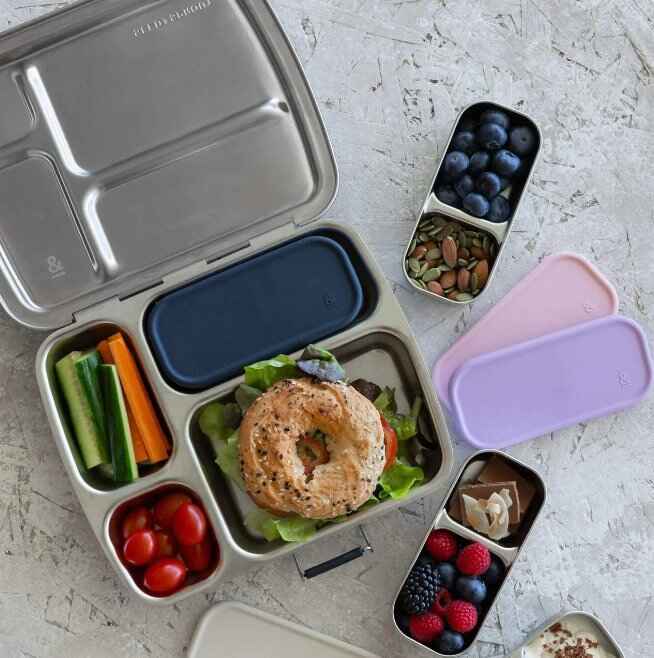 Seed & Sprout CrunchBox™ lunch box and split snack pots styled with a packed lunch and snacks.