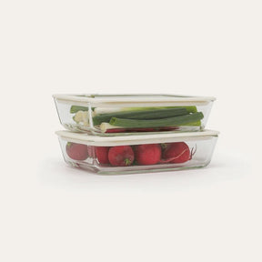 Seed & Sprout Rectangle Glass Food Containers stacked with fresh spring onions and radishes.