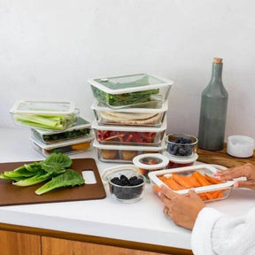Seed & Sprout glass food containers and prep bowls organized on a kitchen counter.