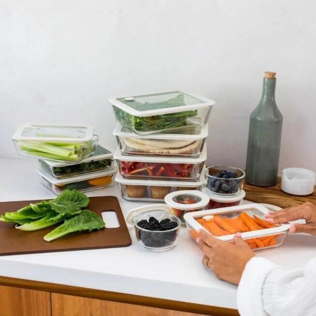 Seed & Sprout glass food containers and prep bowls organized on a kitchen counter.