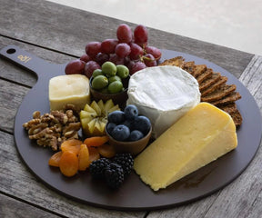 Seed & Sprout Limited Edition Round Wood Fibre Chopping Board styled as an antipasto and cheese platter.