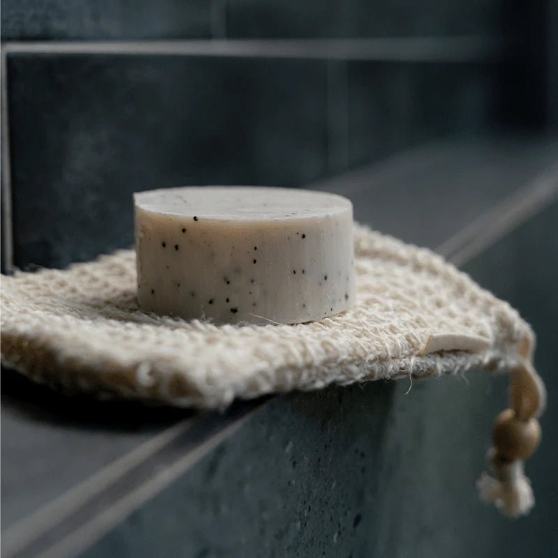 eed & Sprout Natural Body Wash Bar and exfoliating soap pouch in a bathroom.