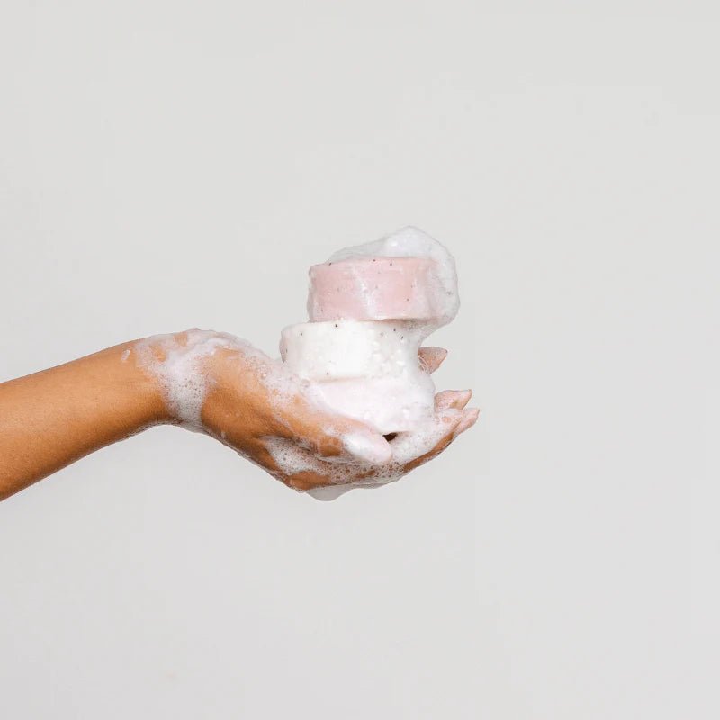 Seed & Sprout eco-friendly solid soap bars lathered in a soapy hand.