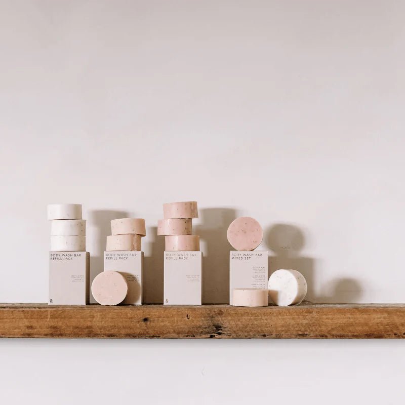 Seed & Sprout Natural Body Wash Bar collection and refill packs displayed on a rustic wooden shelf.