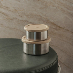Seed & Sprout stainless steel nesting containers with soft almond beige silicone lids stacked