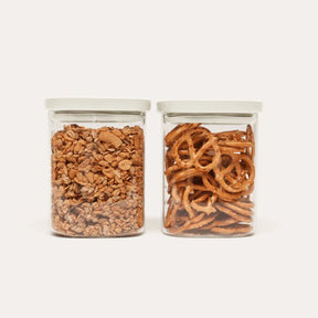 Seed & Sprout Newrybar Square Glass Pantry Jars 1000ml 2-pack filled with granola and pretzels.