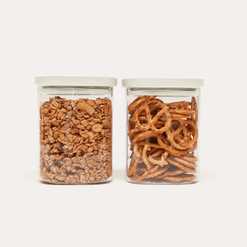 Seed & Sprout Newrybar Square Glass Pantry Jars 1000ml 2-pack filled with granola and pretzels.