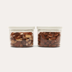 Seed & Sprout Newrybar Square Glass Pantry Jars 500ml 2-pack filled with nuts.