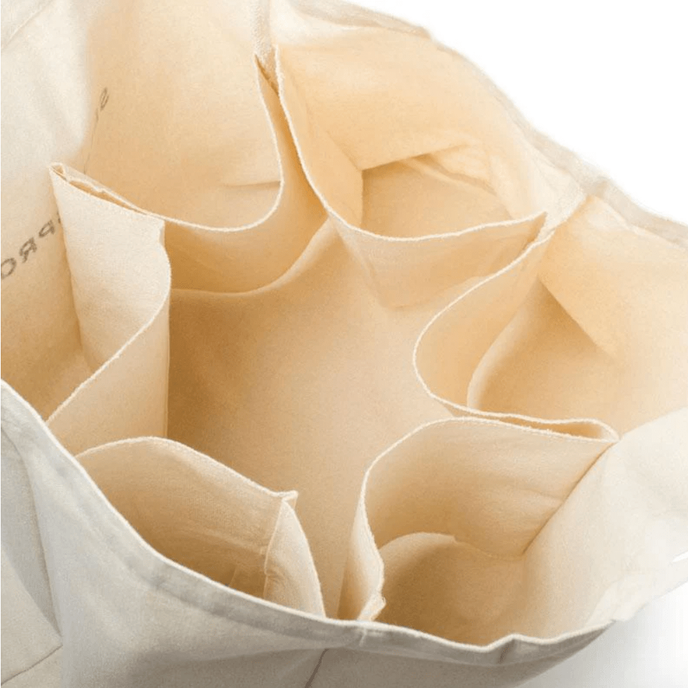Top-down view inside the empty Seed & Sprout organic canvas market bag showing six internal fabric compartments and bottle dividers.
