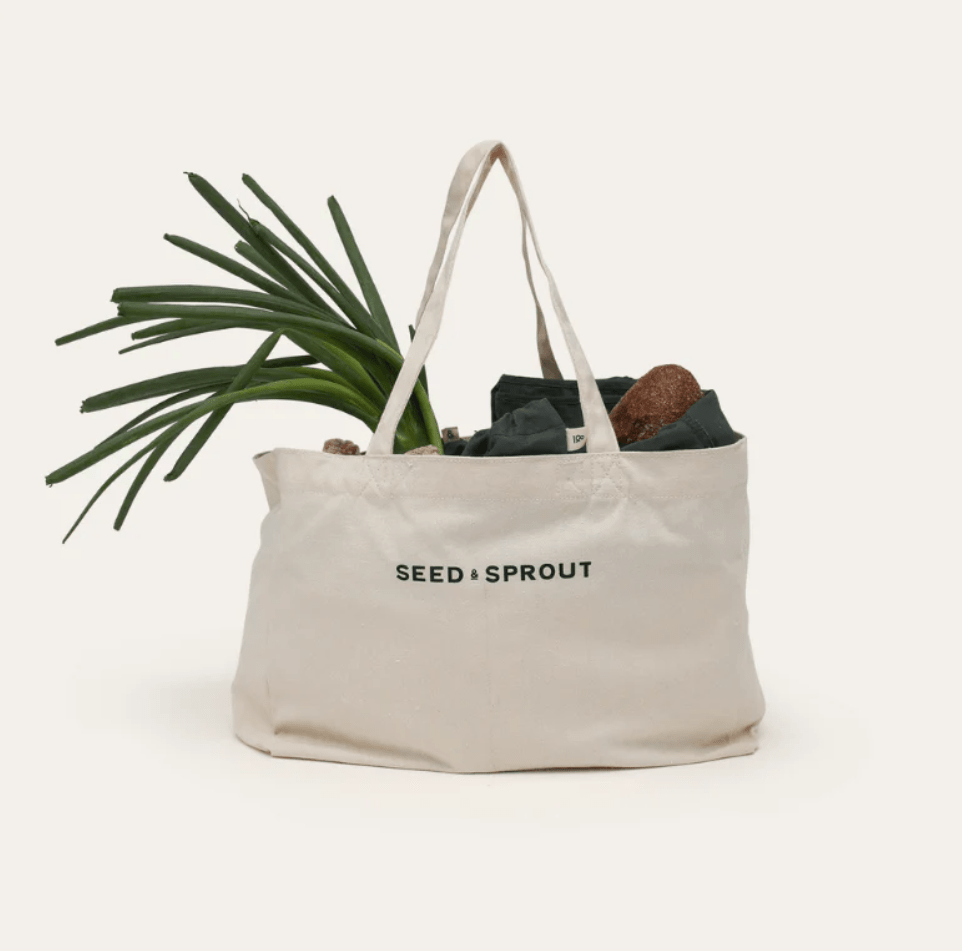 Seed & Sprout natural organic cotton tote bag filled with fresh spring onions and market produce.