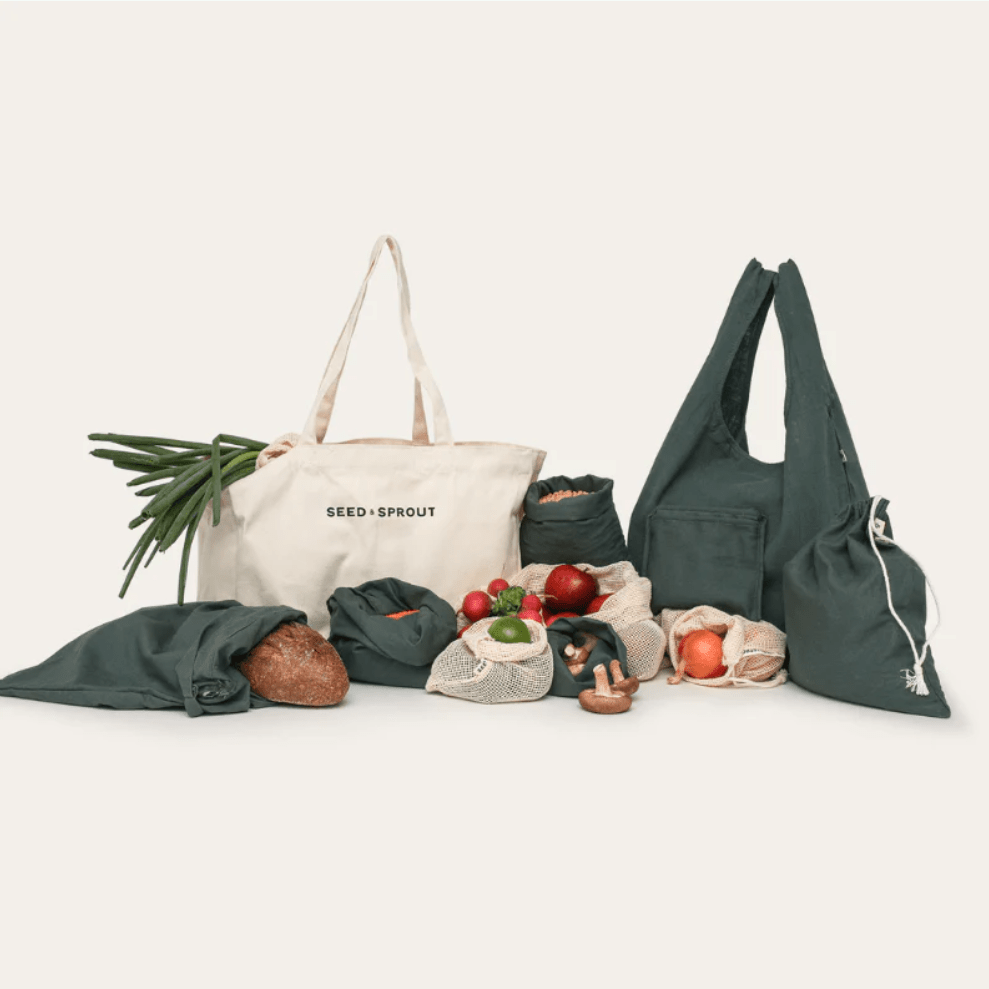 Complete Seed & Sprout Organic Farmers Market Set including canvas shopping totes, organic mesh produce bags, and charcoal bulk bags filled with groceries.