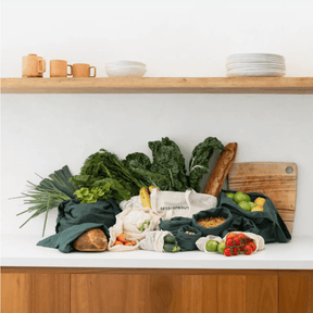 Seed & Sprout Organic Farmers Market Set displayed on a modern kitchen benchtop filled with fresh produce, leafy greens, and bakery bread.