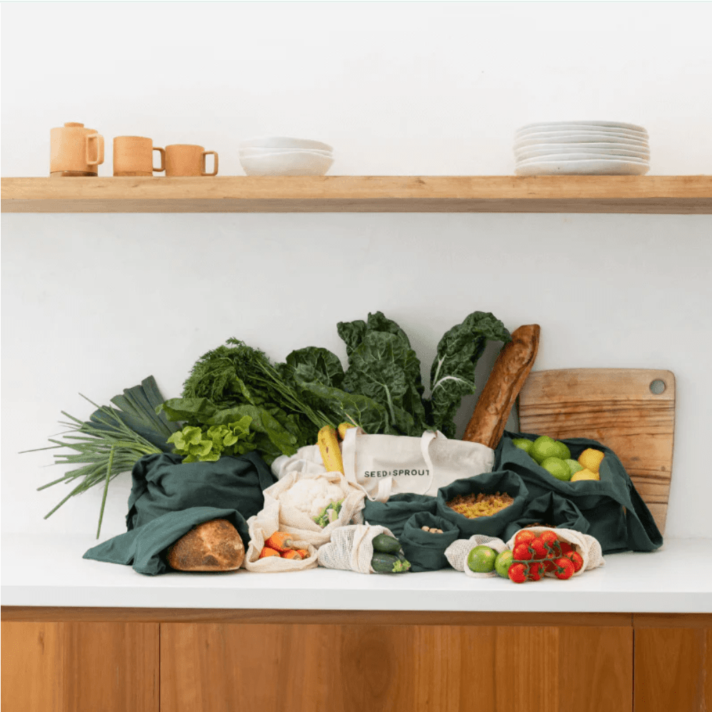 Seed & Sprout Organic Farmers Market Set displayed on a modern kitchen benchtop filled with fresh produce, leafy greens, and bakery bread.