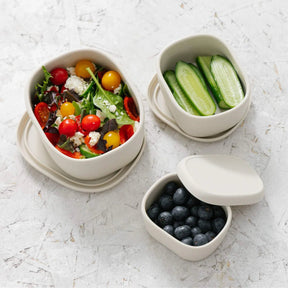Seed & Sprout Silicone Nesting Containers filled with healthy meal prep foods.