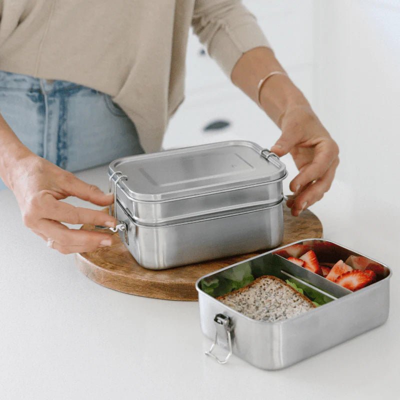 Seed & Sprout stainless steel lunch boxes set up for meal prep in a kitchen.