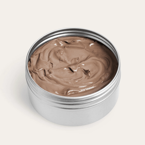 Seed & Sprout SPF 50 bronze tint sunscreen in an open recyclable tin.