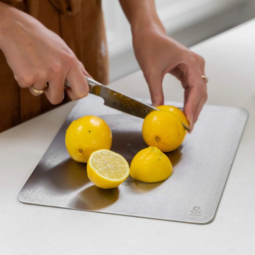 Seed & Sprout Titanium Cutting Board used for slicing lemons.   
