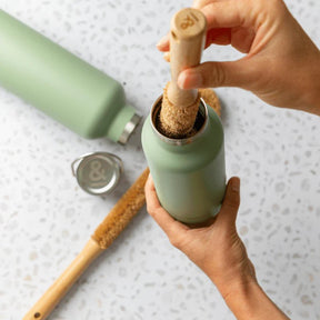 Seed & Sprout Beechwood Bottle Brush cleaning an insulated drink flask.