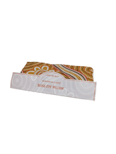 Thurlby Herb Farm Bliss Eye Pillow in an Australian Bush blend, featuring a warm yellow, orange, and brown dot-art pattern fabric wrapped in a branded paper band