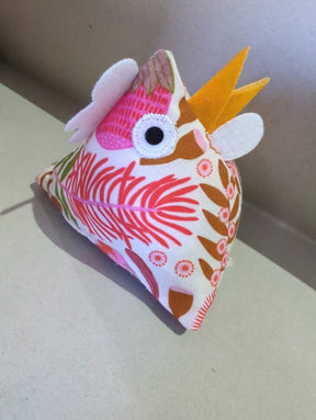 Thurlby Herb Farm Kitchen Pantry Poultry Coloured made from white fabric featuring a vibrant pink and orange botanical print, complete with a yellow beak, white crest details, and an embroidered eye.