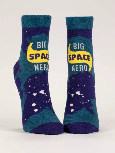 A pair of Blue Q ankle socks with the text 'BIG SPACE NERD' on a cosmic background with stars and a crescent moon.