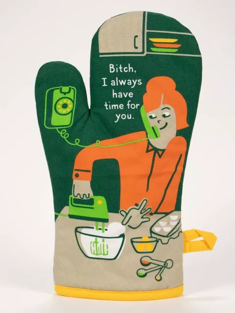 A green and orange retro-styled Blue Q oven mitt illustrating a woman mixing batter while talking on a wall phone, printed with "Bitch, I always have time for you."