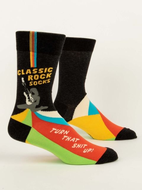 Pair of Blue Q men's black crew socks featuring a guitarist graphic with text reading "CLASSIC ROCK SOCKS" and "TURN THAT SHIT UP!"