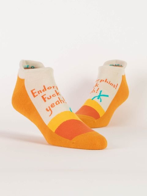 Pair of Blue Q low-cut sneaker socks in cream, yellow, and orange reading "Endorphins! Fuck yeah!"