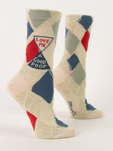 A pair of cream Blue Q women's crew socks featuring a geometric argyle diamond pattern and an hourglass motif reading "LOVE ME A GOOD POOP."