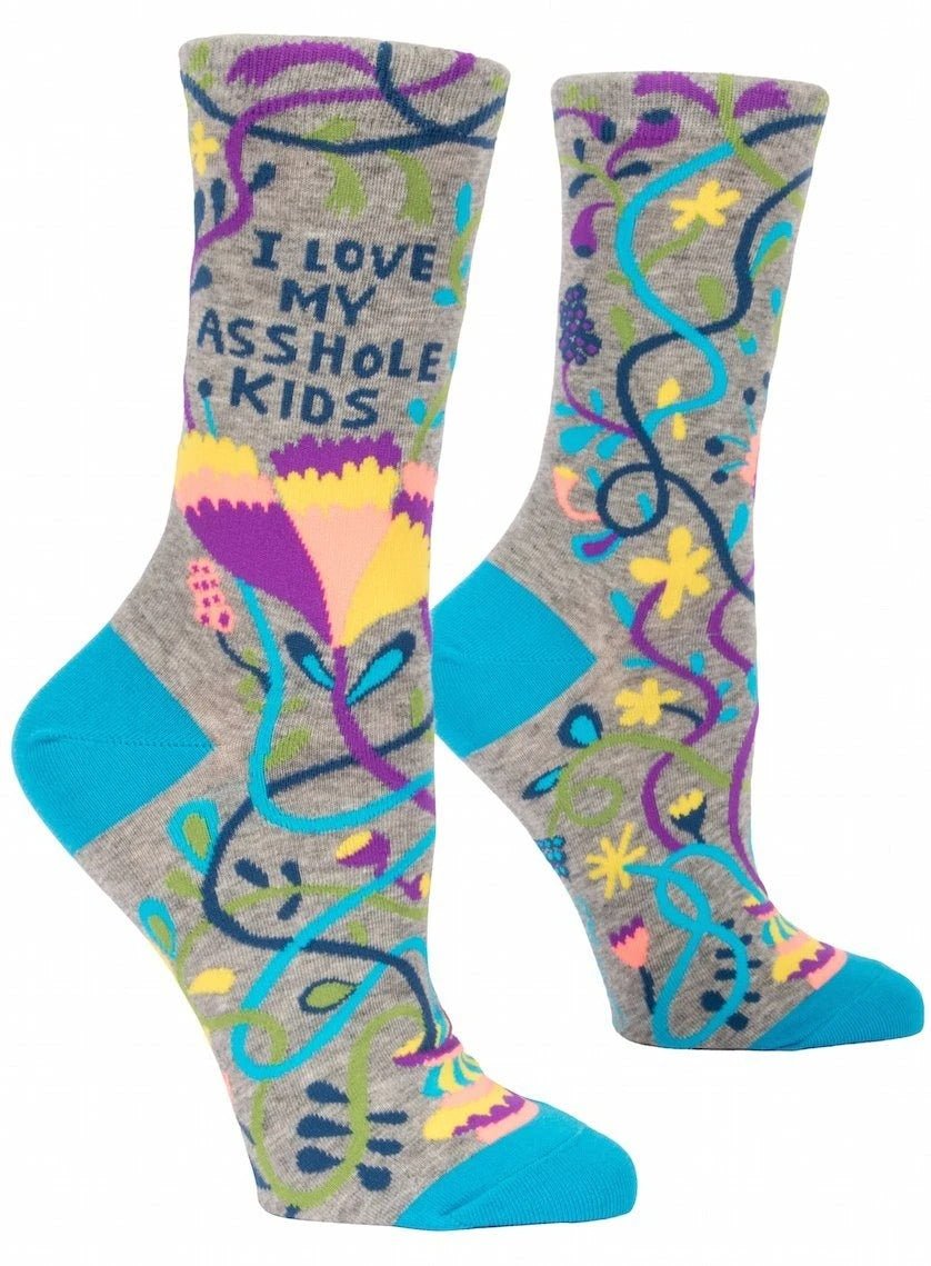 Pair of Blue Q women's grey crew socks with a colorful floral vine pattern and dark blue text reading "I LOVE MY ASSHOLE KIDS."
