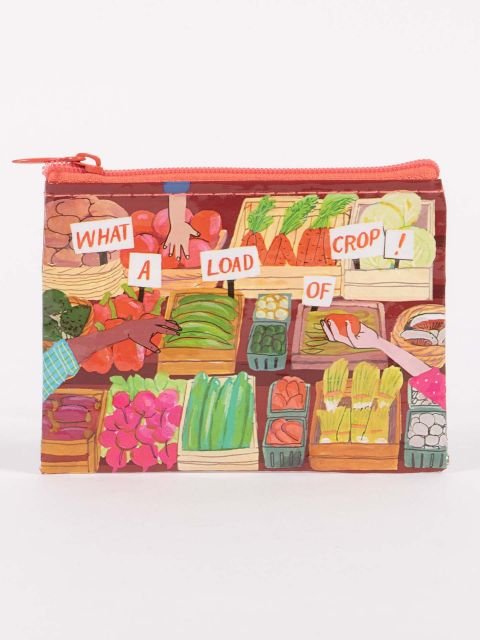 A Blue Q zippered coin purse featuring a colorful farmers market produce stall illustration with cut-out style text reading "WHAT A LOAD OF CROP!"