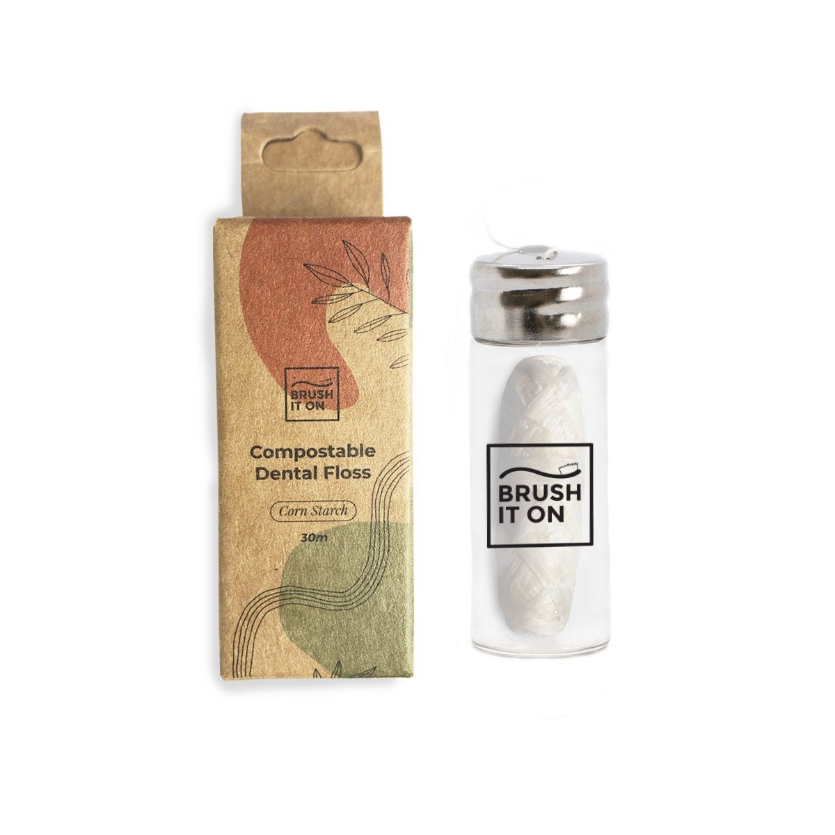 Brush It On compostable corn starch dental floss in a reusable glass container with a metal dispenser cap, shown alongside its recyclable cardboard packaging