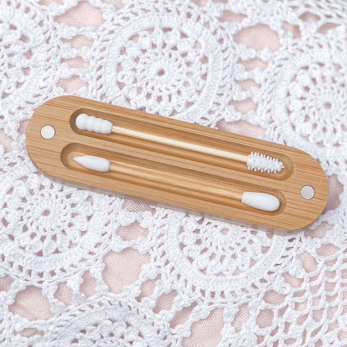 Brush It On reusable silicone buds with bamboo handles resting inside a bamboo magnetic case top-down view